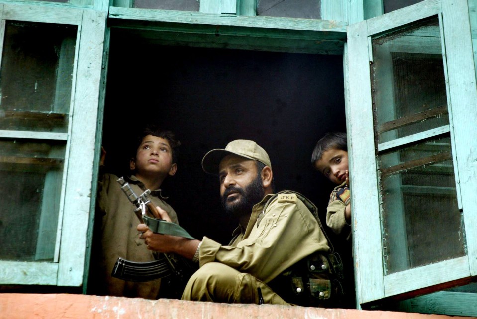 A security personnel keeps guard at a house after a militant attack at Doda, in Kashmir state