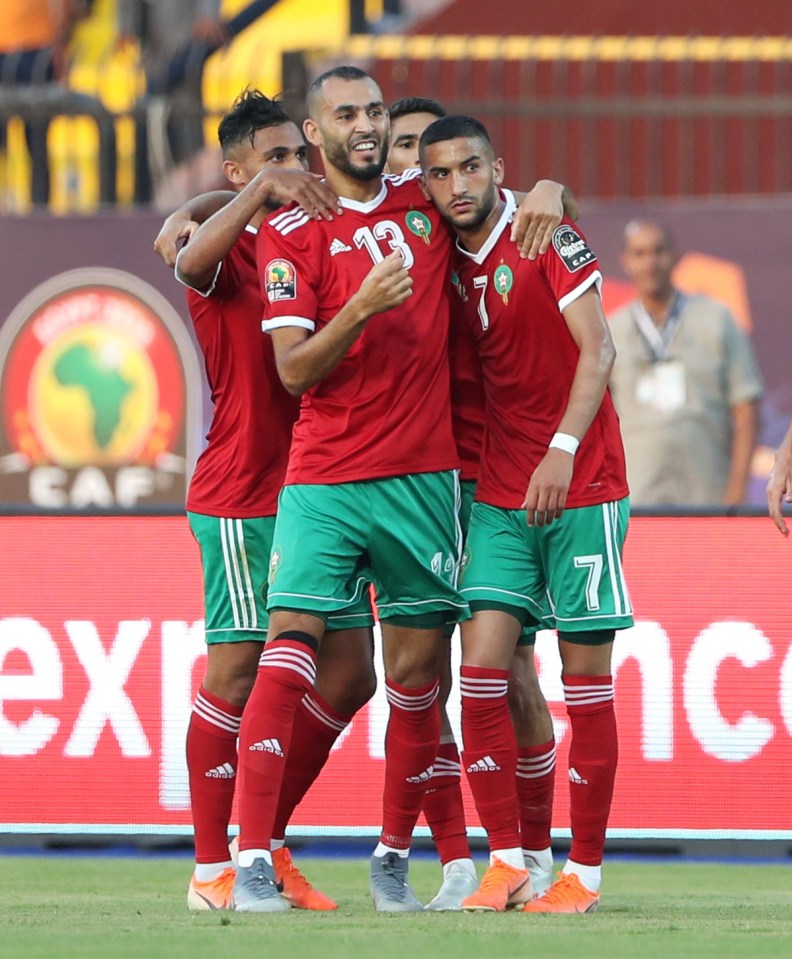 Hakim Ziyech (right) is hailed by his Morocco team-mates after scoring a goal last night