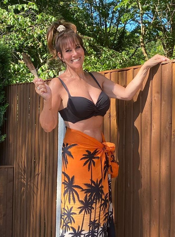 Linda Lusardi painting her fence in a bikini after her Covid battle