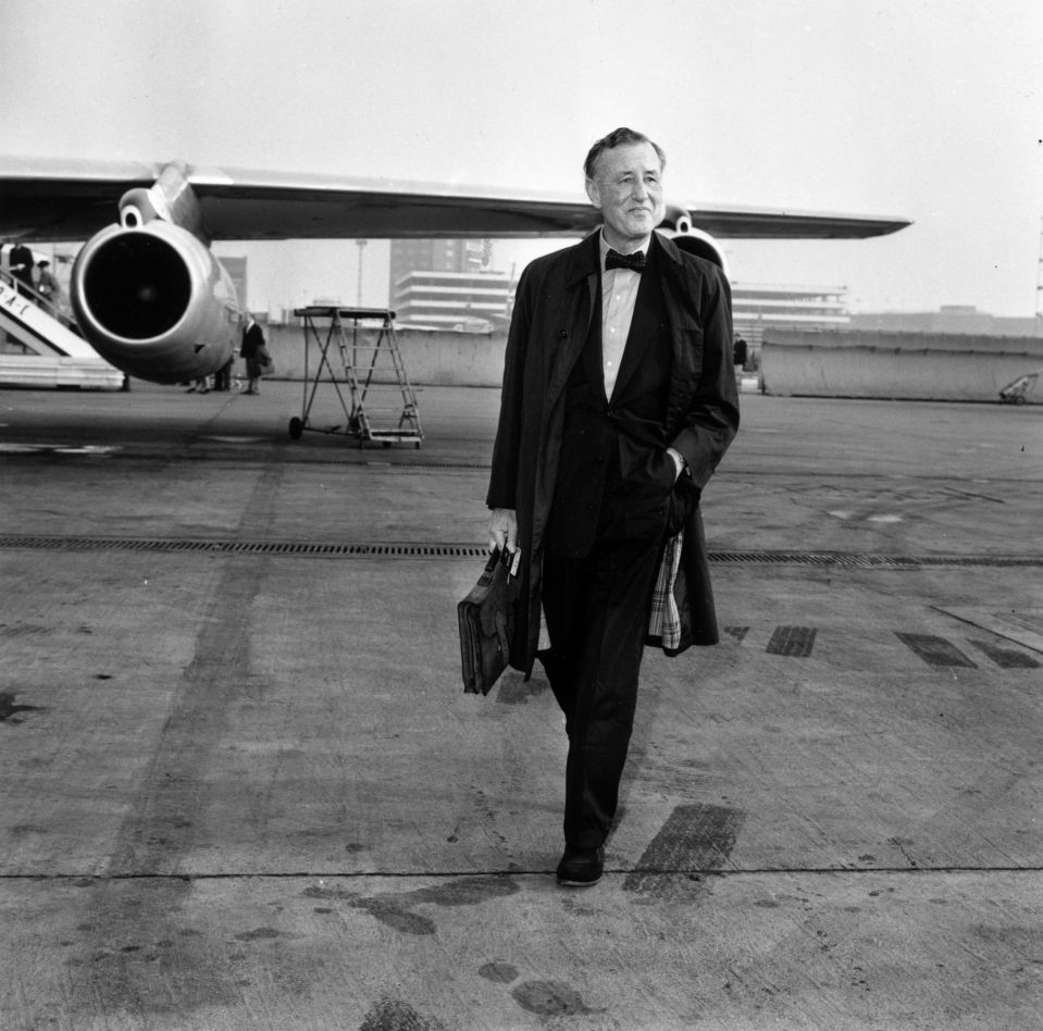 James Bond author Ian Fleming pictured on an airfield in 1964