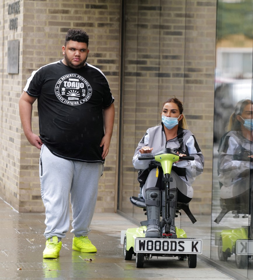 Harvey alongside mum Katie – on her personalised mobility scooter