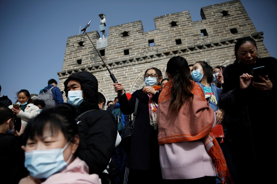 Visitors wearing masks at the Great Wall in Beijing, China