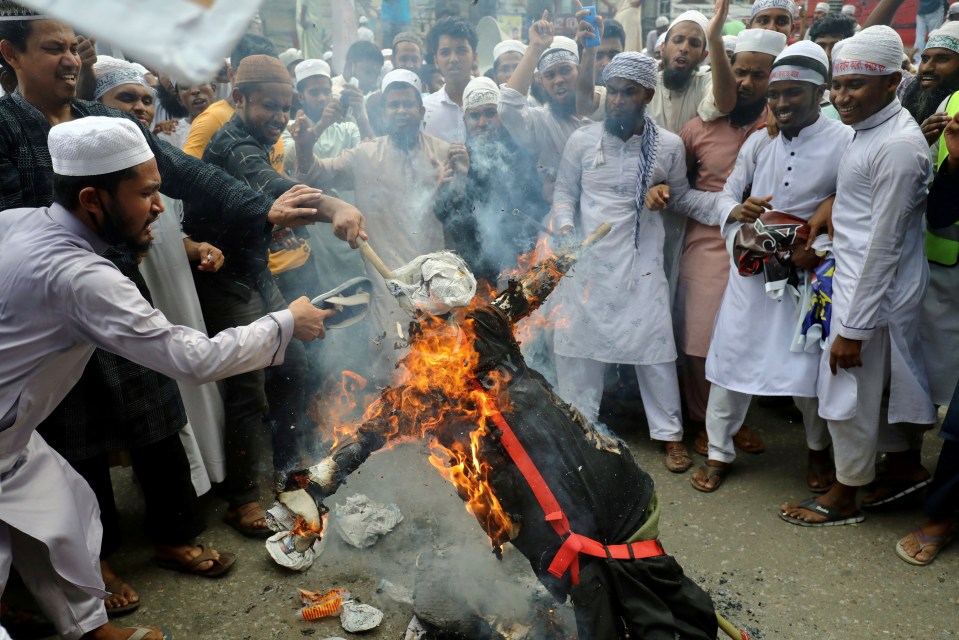 Protesters burn an effigy of French president Emmanuel Macron in Bangladesh 