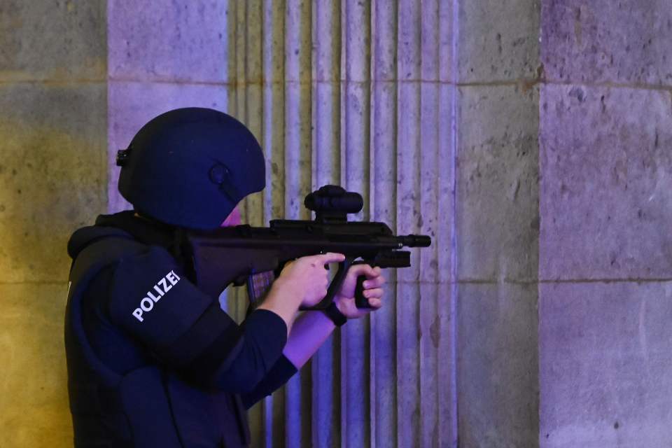 An armed police officer keeps an eye in Schwedenplatz