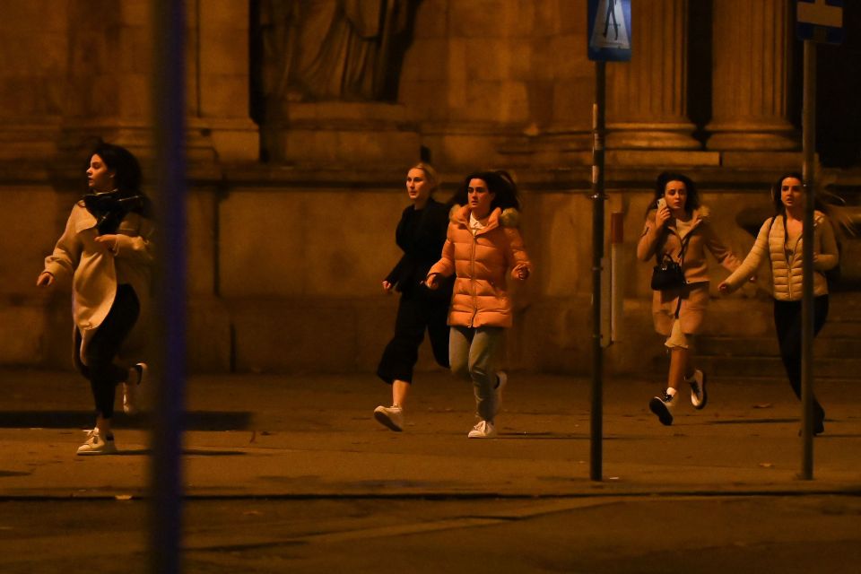 Women run to safety as Vienna after residents were warned to stay indoors