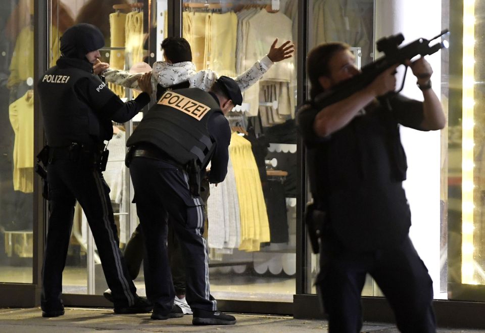 A man is searched by cops as they hunt for the terrorists in Vienna