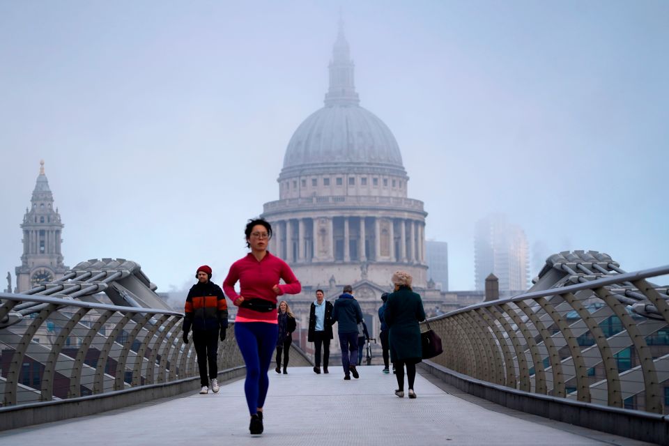 People making their way over the Millennium Bridge near St Pauls