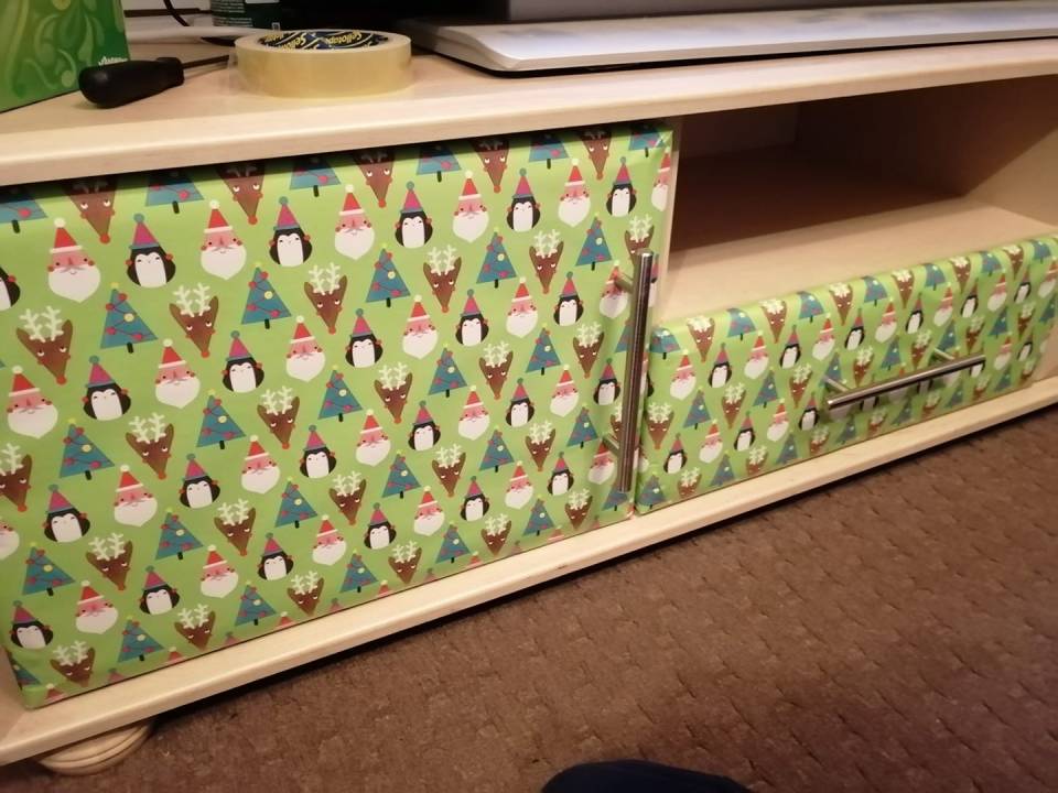 A man shared how he has wrapped his cupboards in Christmas paper to bring some extra festive cheer to his home