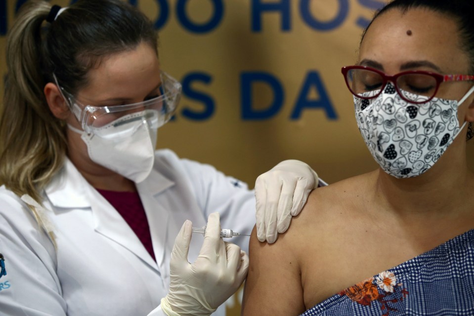 A nurse gives a Covid-19 vaccine to a volunteer in Porto Alegre