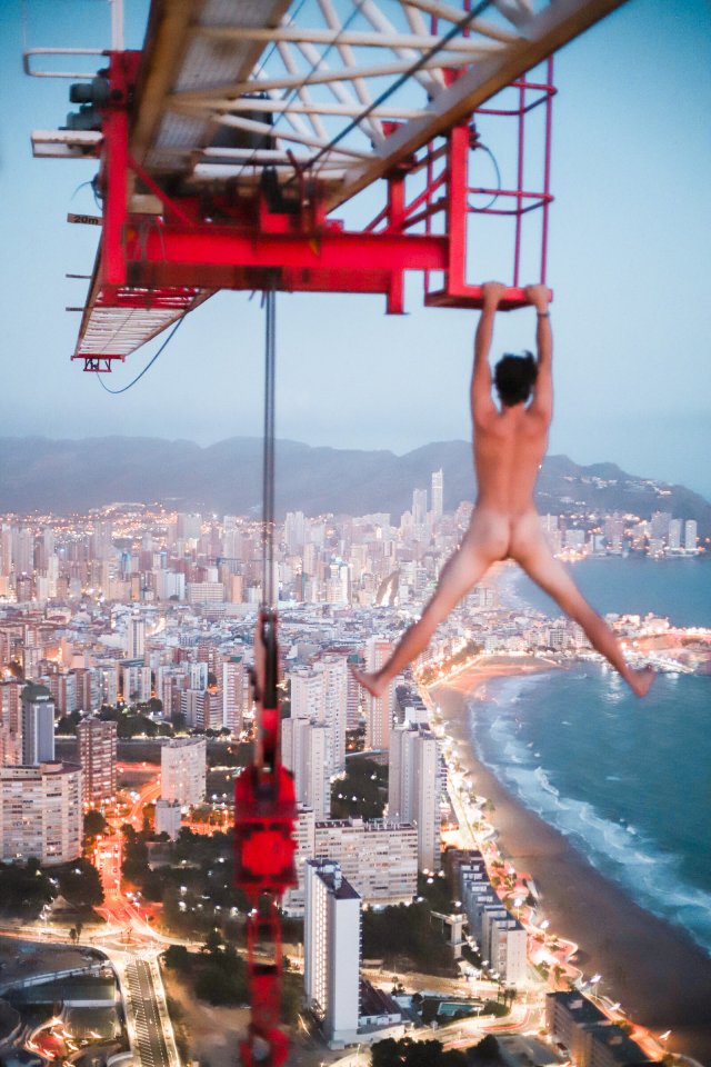 The teenage daredevil had a great view of Benidorm as he dangled naked from a 660ft crane