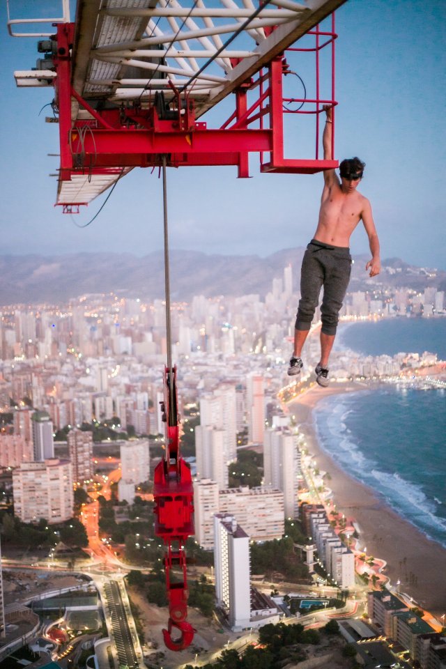 Adam Lockwood scaled the crane wearing his climbing trousers, but soon shed all his clothes