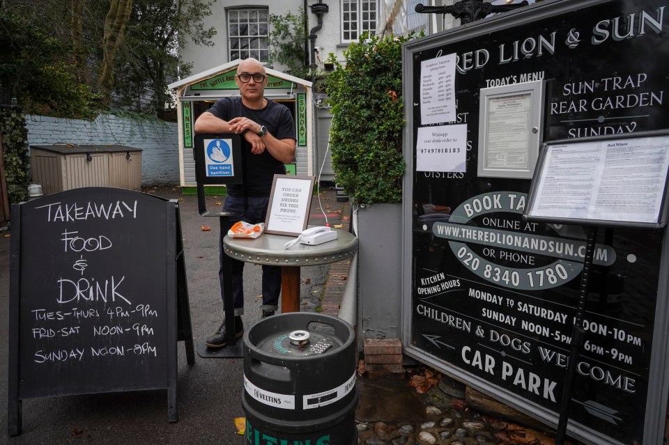 The phone is positioned at the entrance to the pub along with hand sanitiser and wipes