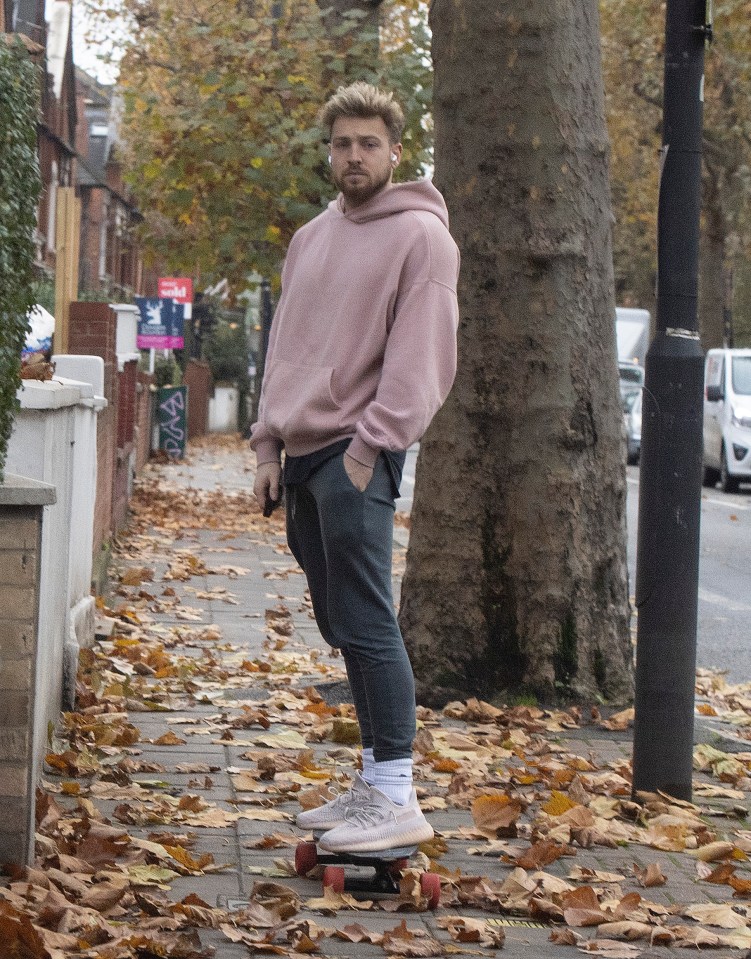 Sam later emerged from his house in a beige jumper and grey joggers