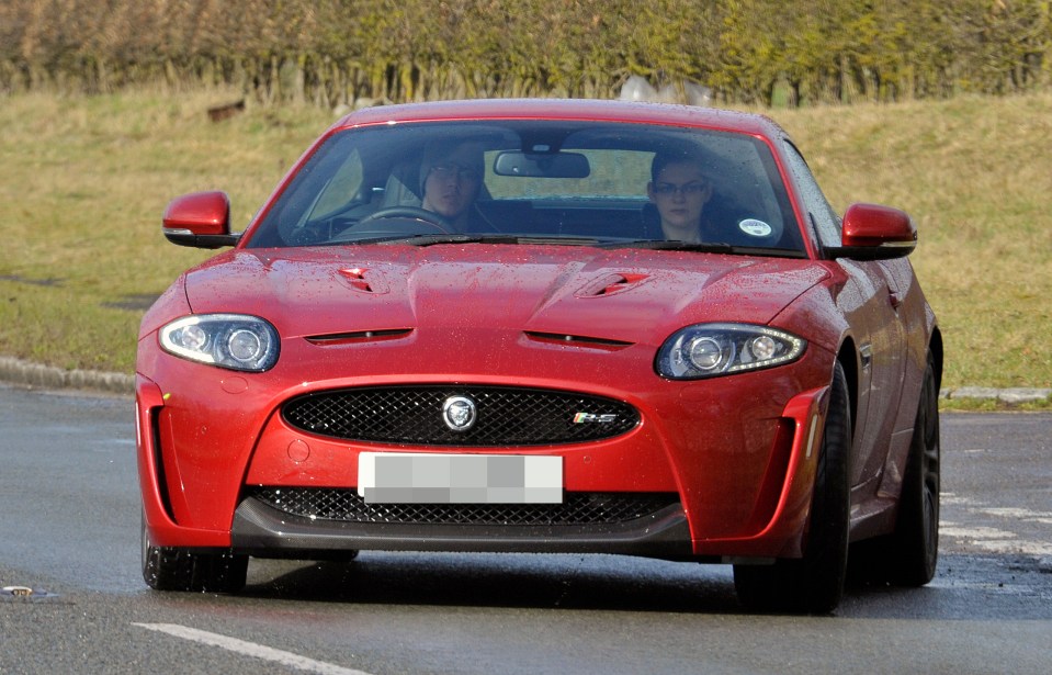 Mr Topham is pictured driving a Jaguar in 2012