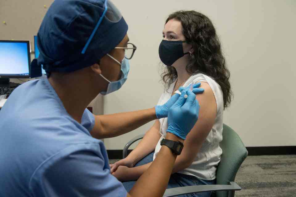 A volunteer receives the Moderna vaccine as part of clinical trials 