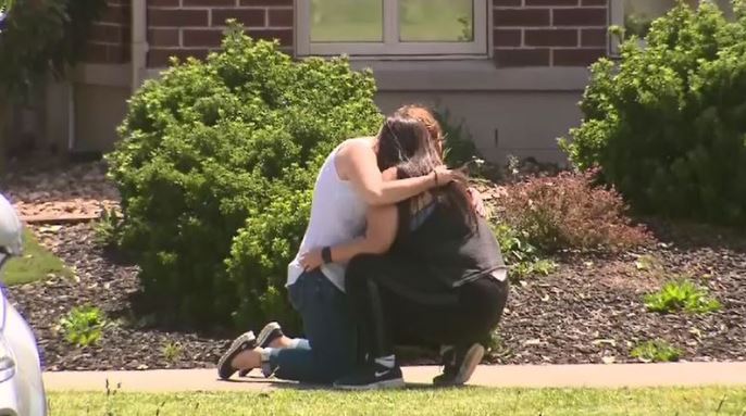 Friends and relatives of Celeste Manno comfort each other outside her home in Melbourne today