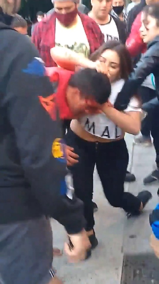 The young woman can be seen scuffling with the suspect before retrieving her smartphone