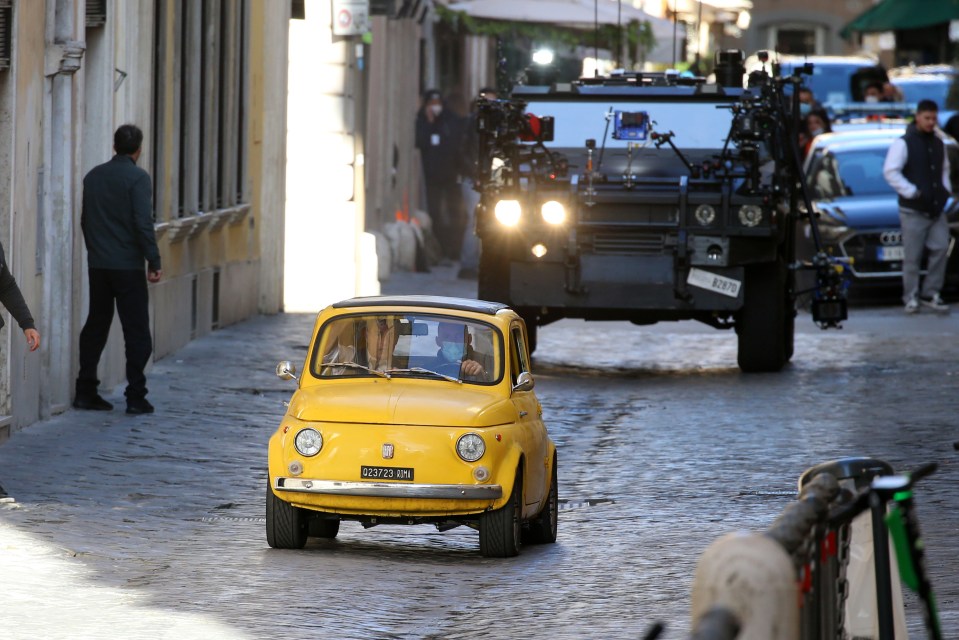 Tom was seen driving an amusingly tiny yellow classic Fiat 500