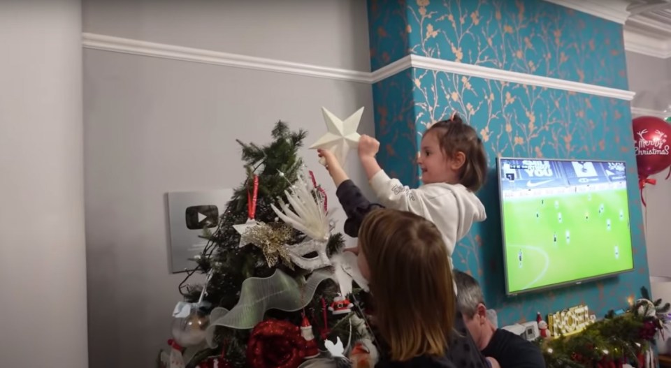 Four-year-old Hallie was nominated to stick the star on the top of the tree