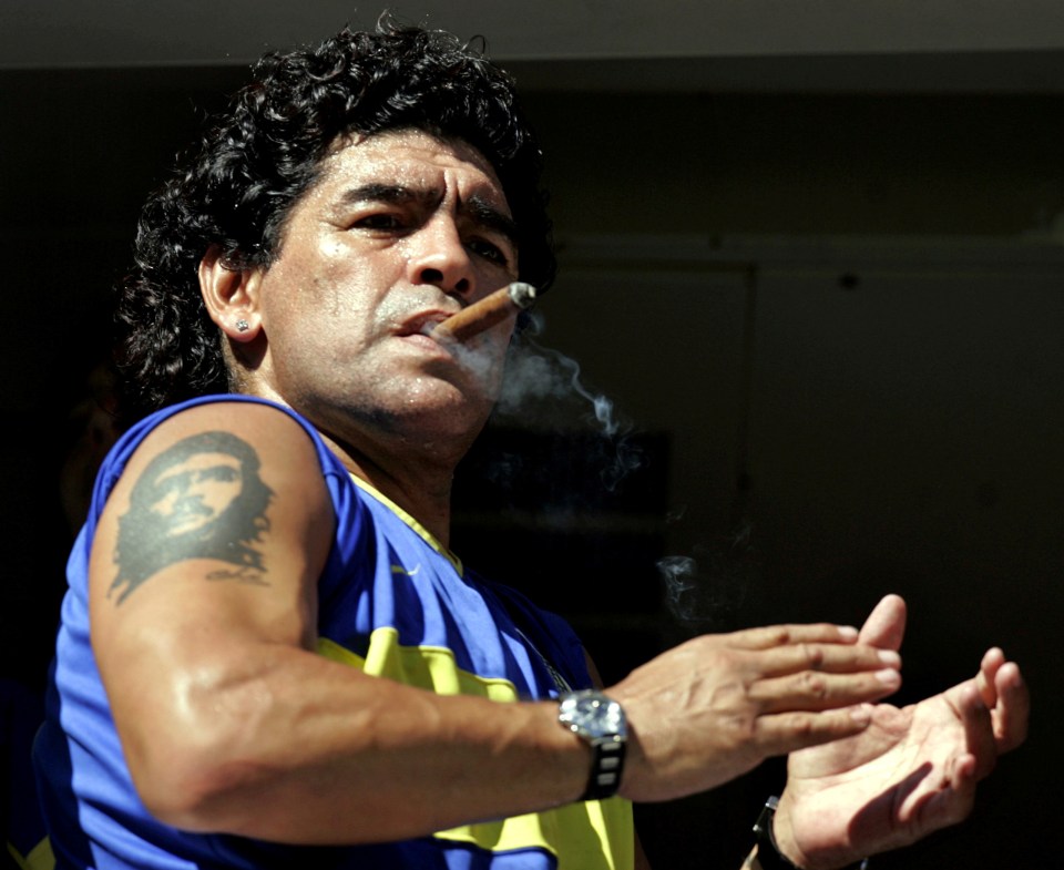 Maradona smokes a cigar before the start of a Boca Juniors match in Buenos Aires in 2006