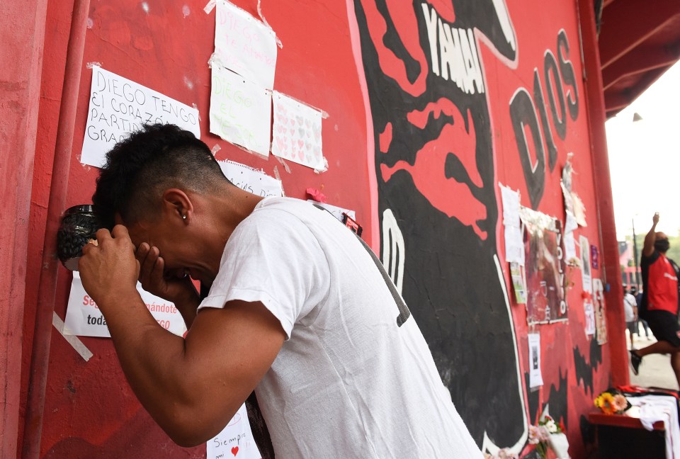 A man sobs outside the Marcelo Biesla stadium in Rosario