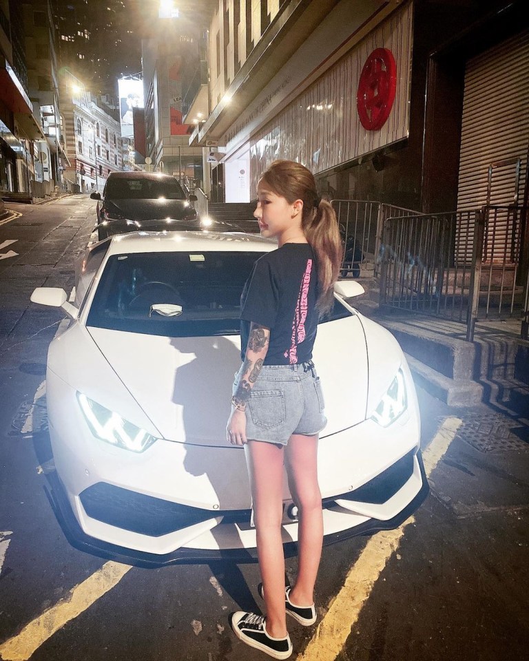 Mei-yan stands in-front of a fancy sports car