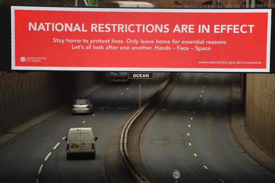 A billboard displays a Manchester City Council message about the national lockdown restrictions