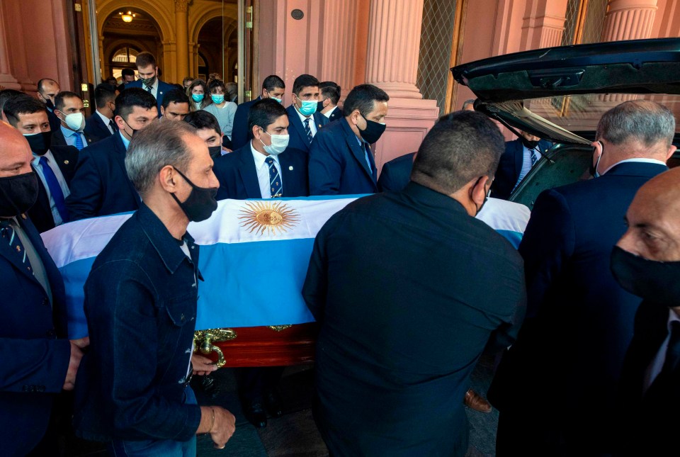 Maradona’s coffin being loaded into the hearse at the presidential palace