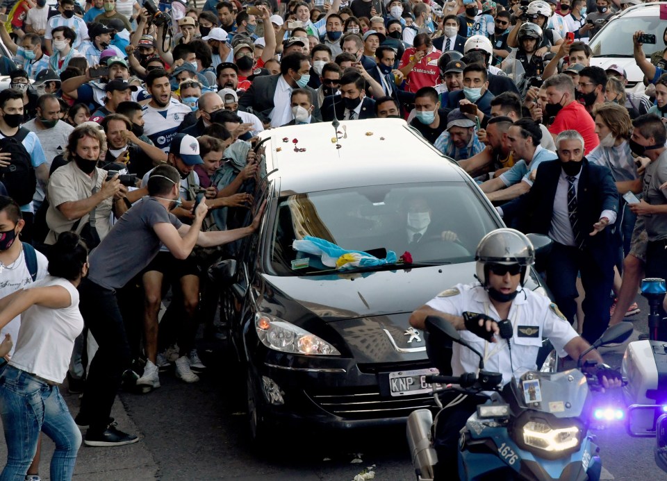 Cars driving through were surrounded by mourners