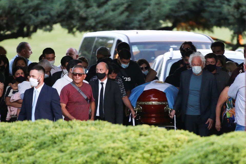 A small group of family and friends carried Diego Maradona’s casket with the flag of Argentina draped over it