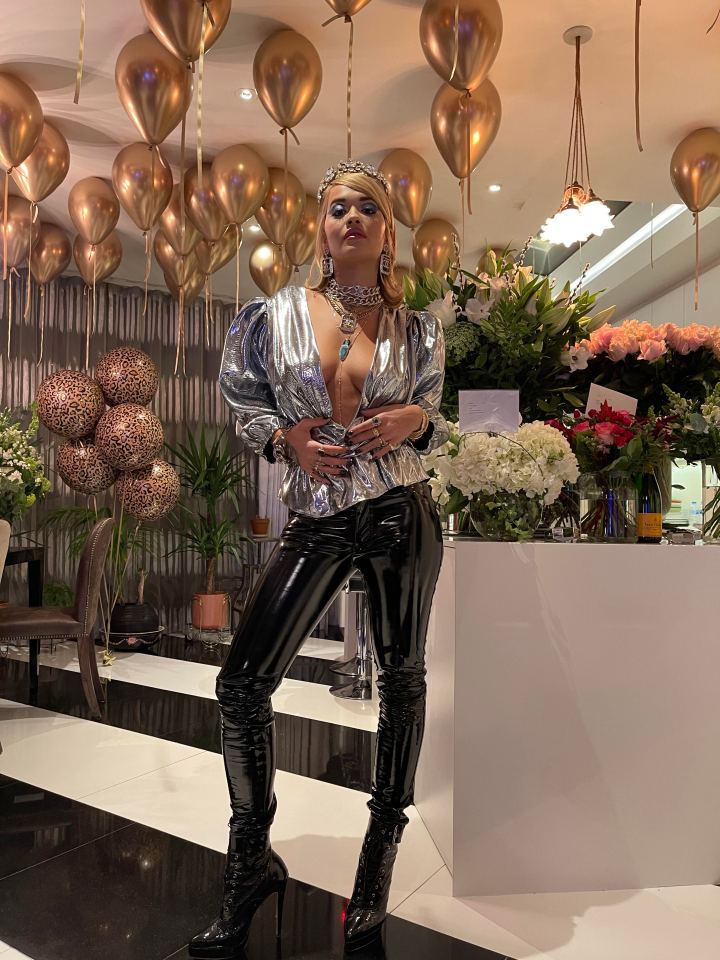 Rita sizzled in her metallic peplum top and skintight leggings as she let her hair down at her home party