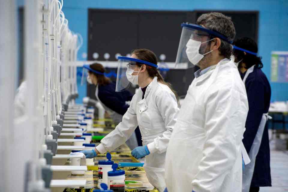  Third-year medical students from the University of St. Andrews, wearing full PPE, wait to receive fellow students' swabs