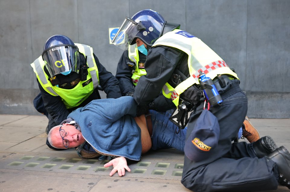 An anti-lockdown protester gets arrested during the demonstrations