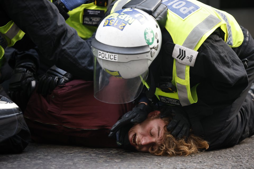 Police arrest an anti-lockdown protesters near Regent Street in central London