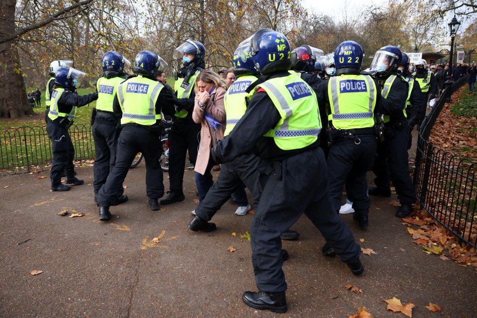 Police block a pathway during an anti-lockdown protest