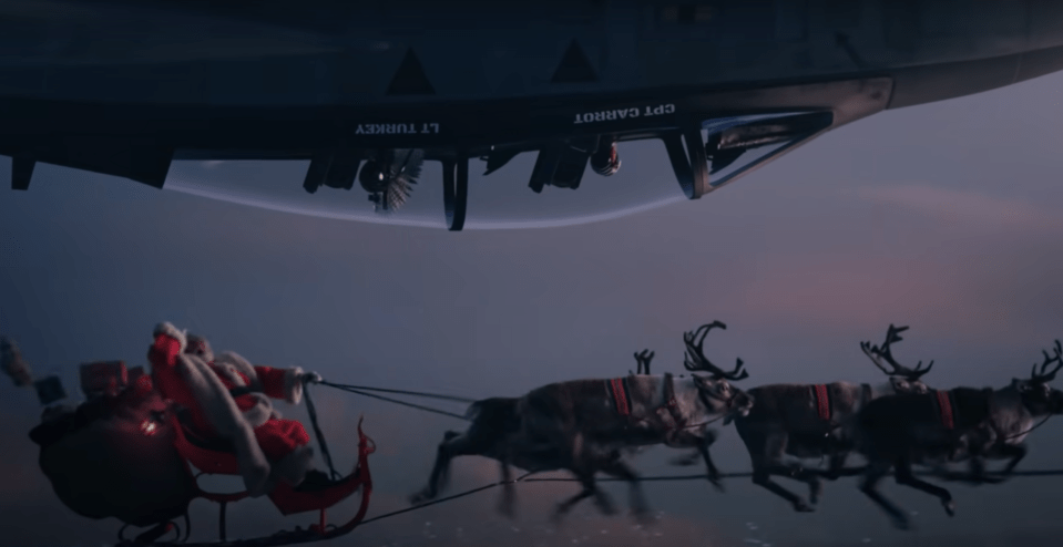 The duo encounters Father Christmas and a bunch of reindeers above a snowy mountain range in the teaser