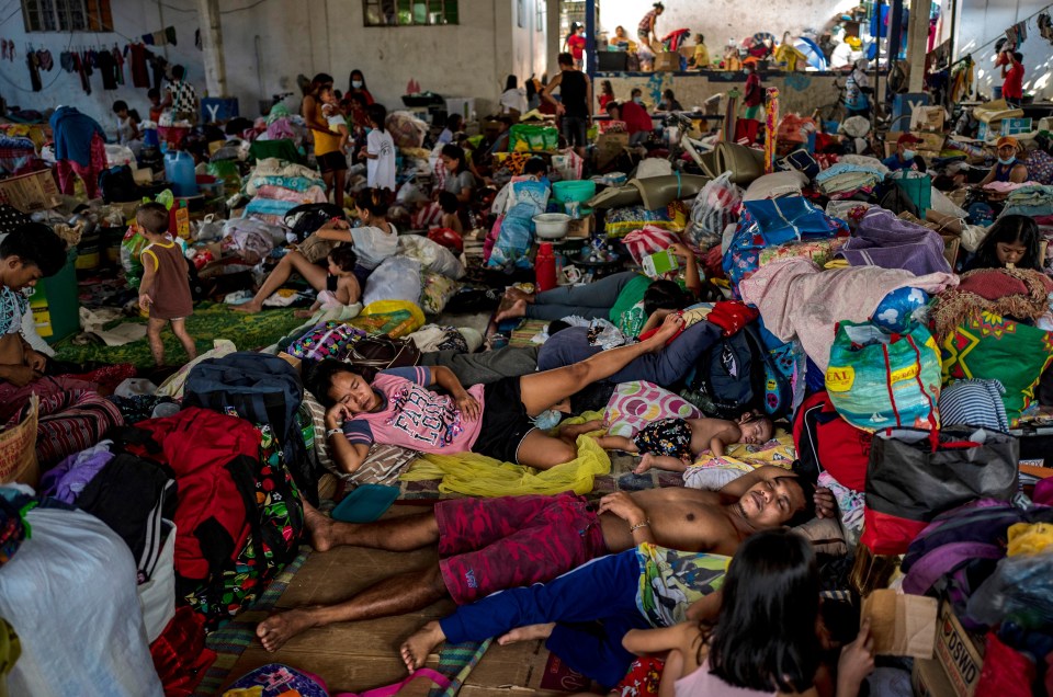 Residents affected by Typhoon Vamco occupy a basketball court converted into an evacuation centre on November 18