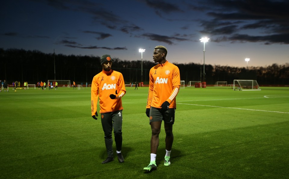 Pogba and Bruno Fernandes chat during training at Carrington