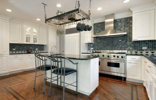 These days the cabinets are gleaming white with dark tiles on the walls