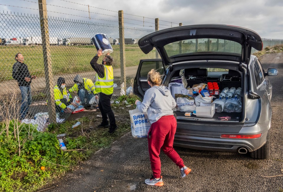 Kent locals were seen passing items like toilet roll over the perimeter fence at the airport