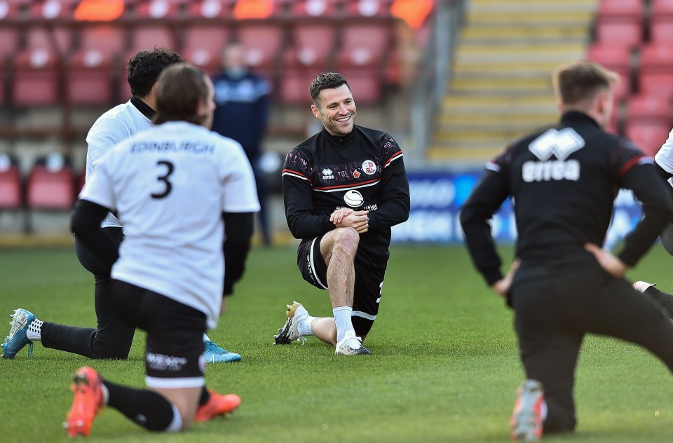 The smiling star joined in with his Crawley Town team-mates' warm-up