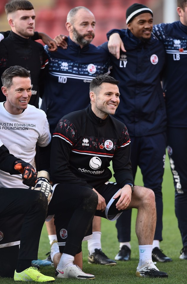 Mark on one knee for a team photo at east London's Breyer Group Stadium