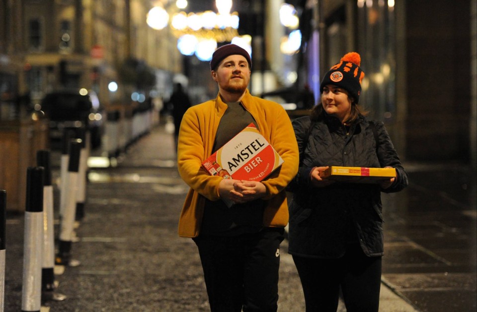 Pals carry pizza and beer in Newcastle