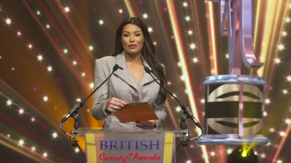 Jess opens a golden envelope to reveal nominations at the awards