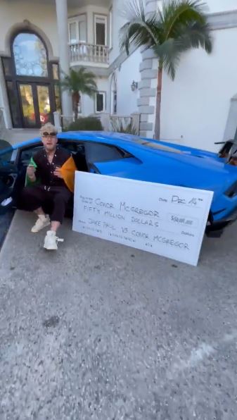 The YouTube star posed alongside the huge cheque 