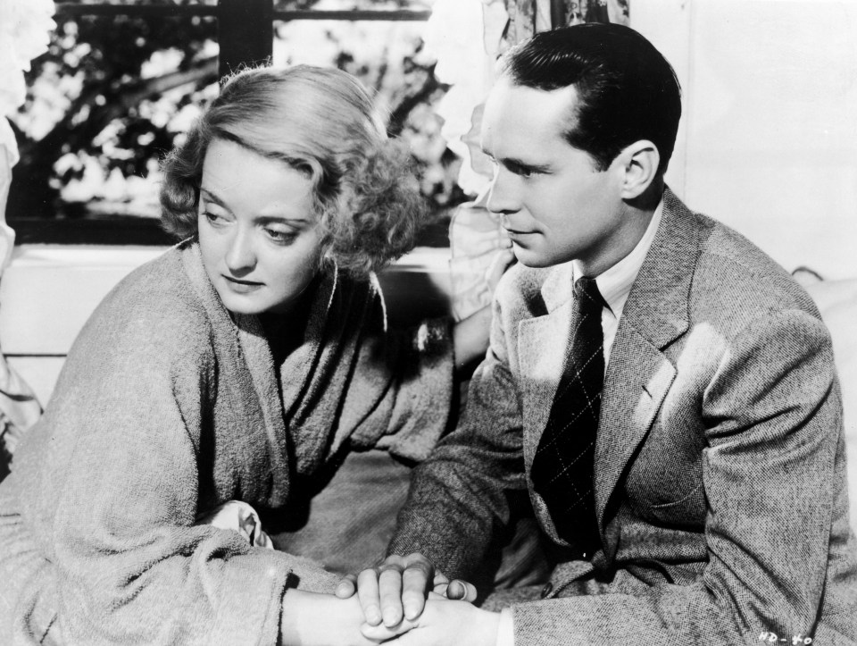 Bette Davis, who won an Oscar for playing Joyce, holds hands with American actor Franchot Tone in Dangerous