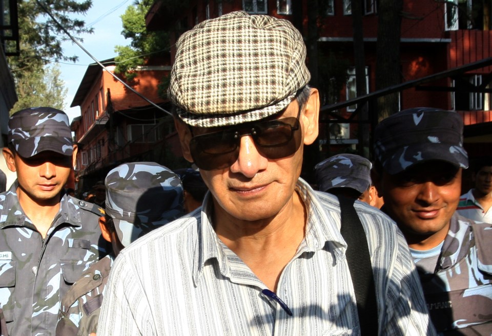 French serial killer Charles Sobhraj is guided by Nepalese policemen after a court hearing in Kathmandu on May 31, 2011