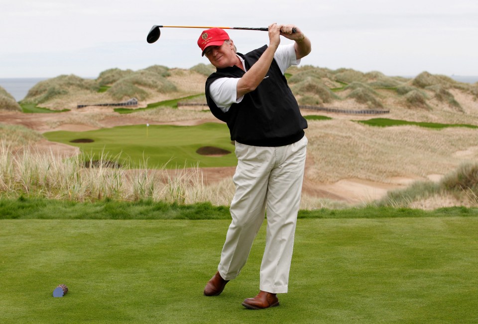 Trump practices his swing at the 13th tee of his new Trump International Golf Links course on the Menie Estate near Aberdeen