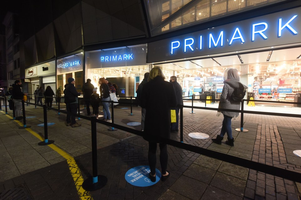 Keen shoppers waiting in queues in the dark as shops opened up again