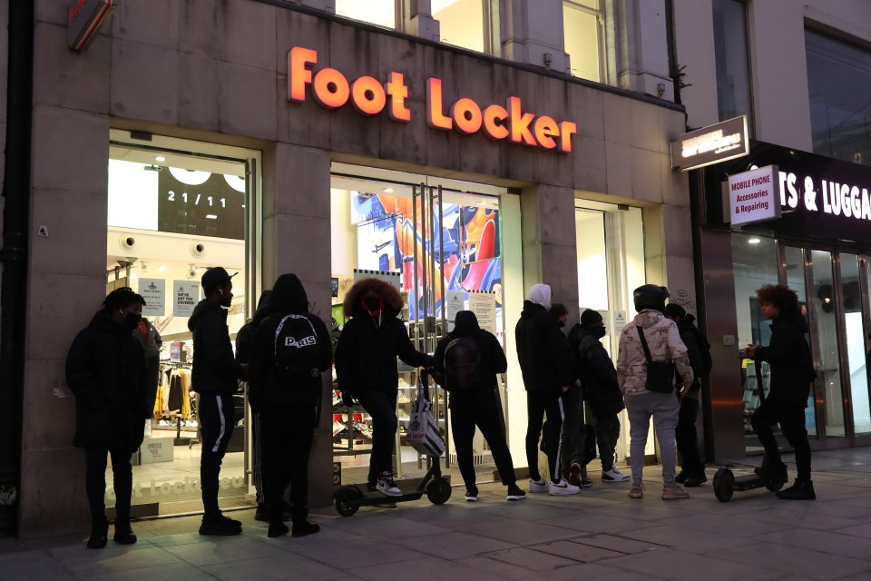 As England moved into the tier system, people waited outside shops this morning